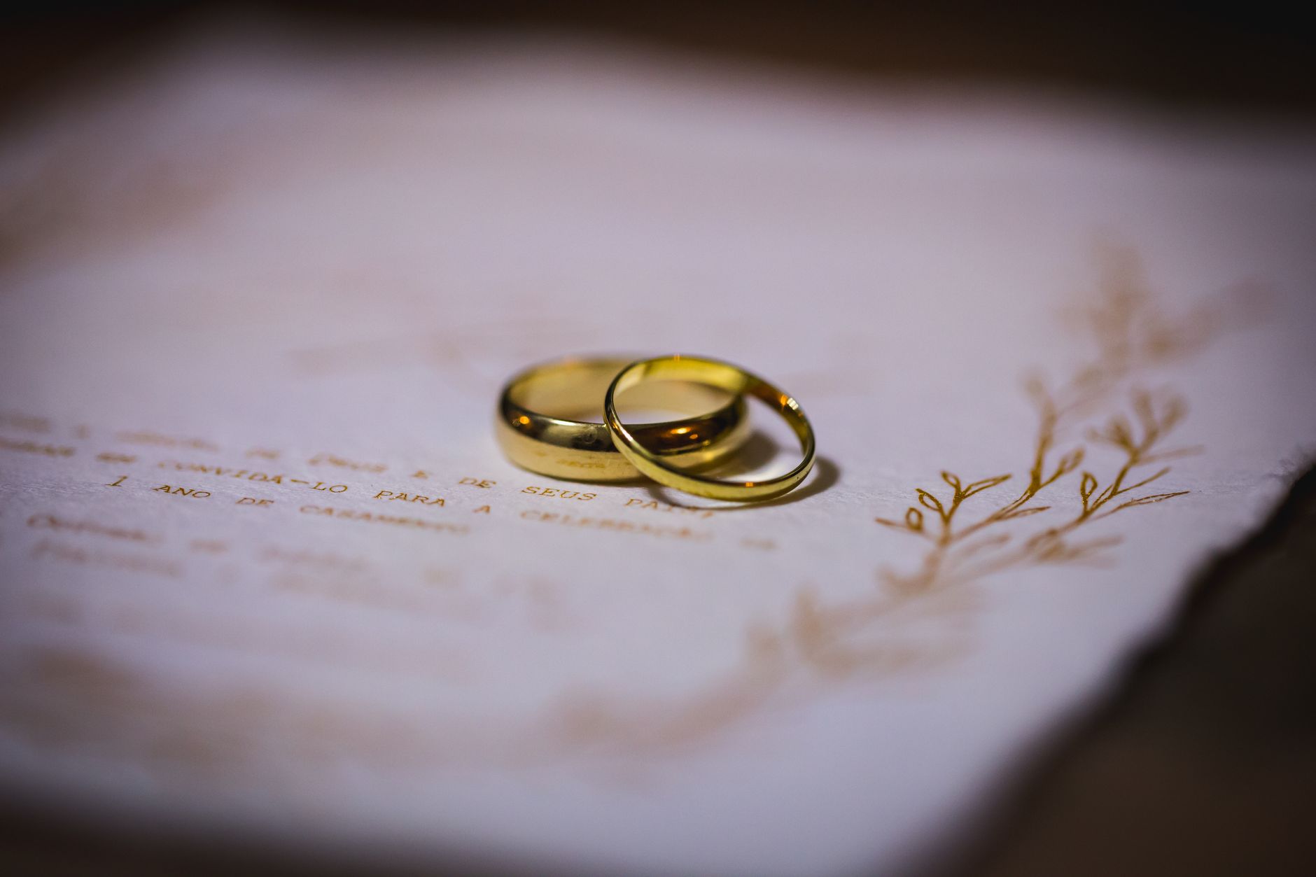 elegant gold wedding rings on invitation